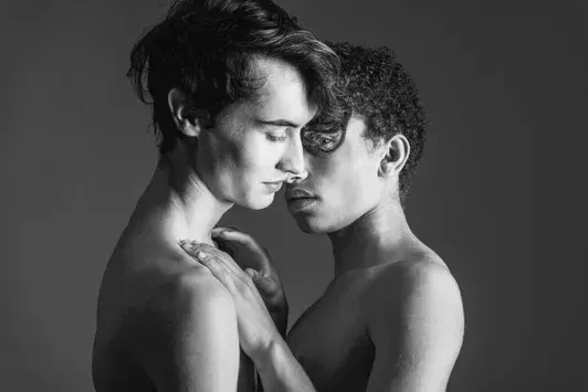 Arjan Spannenburg fine art photography titled Propensity, featuring a close-up profile of two men in a moment of intimate recognition.